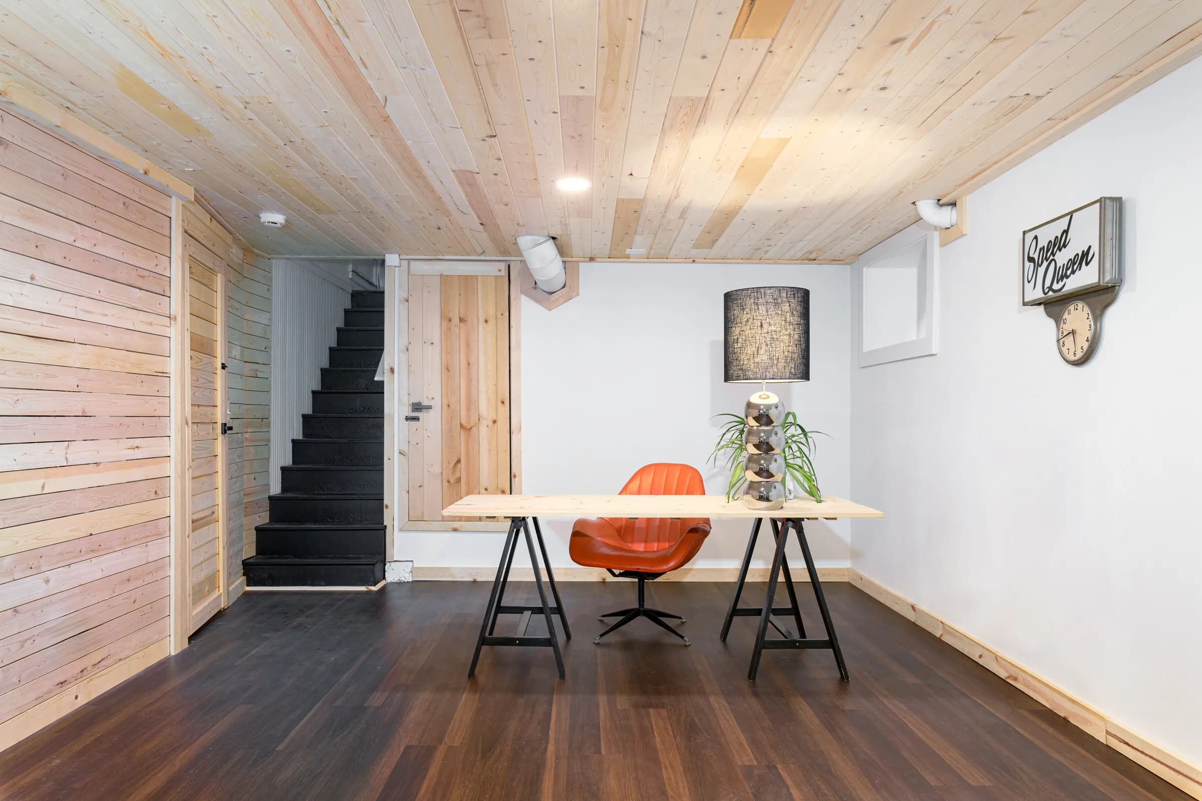Finished SE Portland basement with a wood-plank ceiling, staircase, and home-office nook