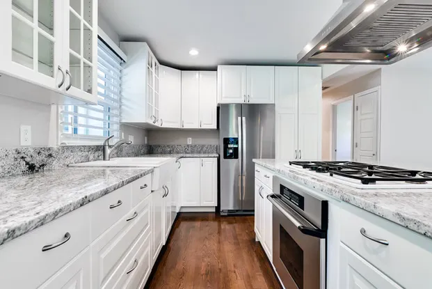 Renovated kitchen in a Lake Oswego home remodel showing custom cabinetry and updated countertops by Tortoise Construction LLC
