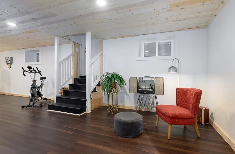 After photo of the completed basement remodel at 923 SE 23rd Avenue, Portland, showing modern finishes, recessed lighting, and functional family living space by Tortoise Construction LLC