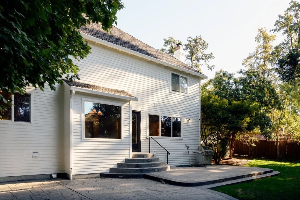 After photo of the renovated Lake Oswego home showing the completed open-concept main floor with kitchen, dining, and living areas flowing together by Tortoise Construction LLC